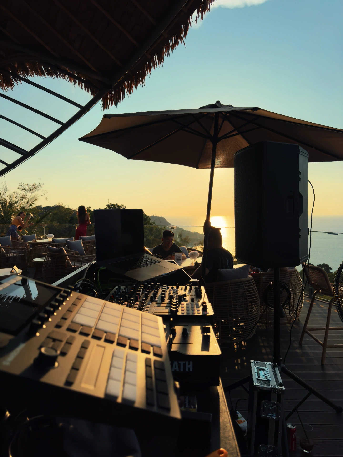 Sunset DJ booth with controller, mixer and speaker overlooking the sea in Phuket